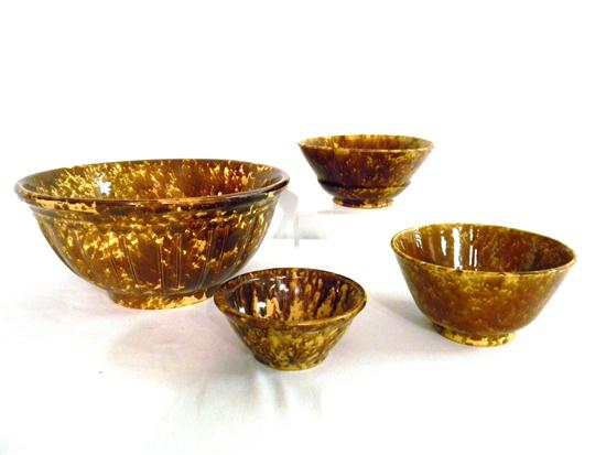 Appraisal: Four Rockingham type glazed bowls in various sizes largest bowl