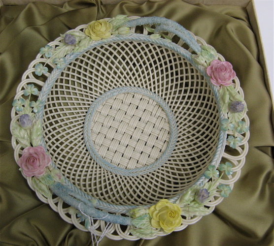 Appraisal: AN IRISH BELLEEK FOUR STRAND SYDENHAM BASKET having painted roses