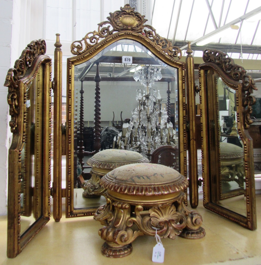 Appraisal: A giltwood carved and pierced triptych dressing table mirror with