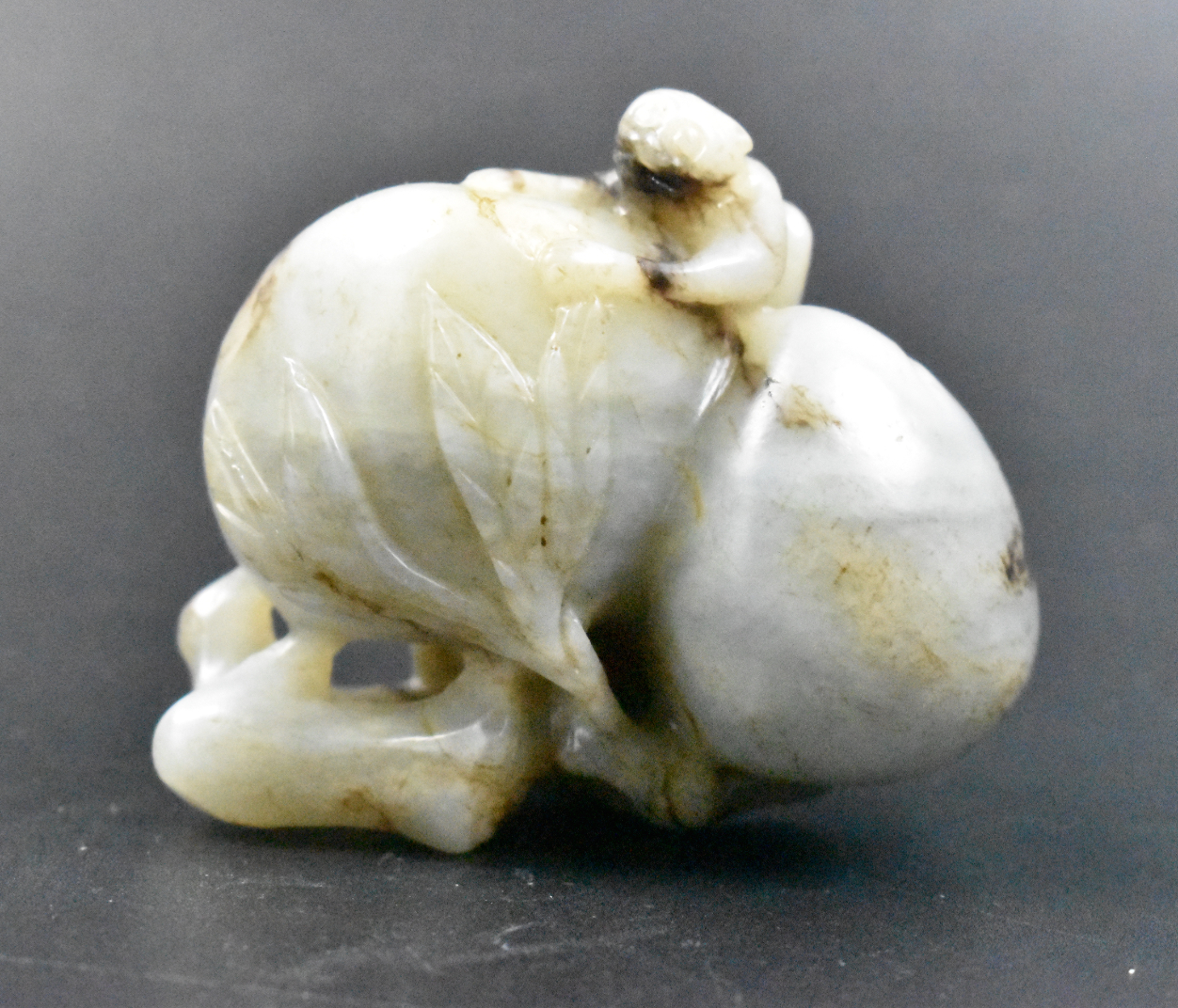 Appraisal: A Chinese jade carved monkey on peaches dating from the