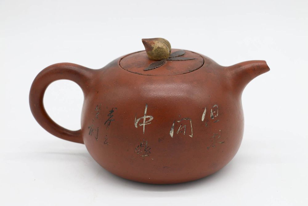 Appraisal: YIXING PEACH-SHAPE TEAPOT of peach shape Incised scholar portrait and