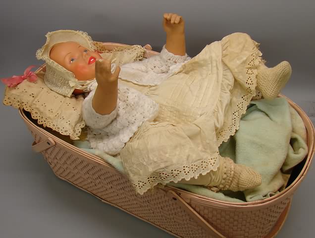 Appraisal: Motorized compo baby in basket-store display Large baby on back