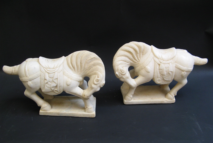 Appraisal: PAIR CHINESE CARVED WHITE MARBLE HORSES Tang style in opposing