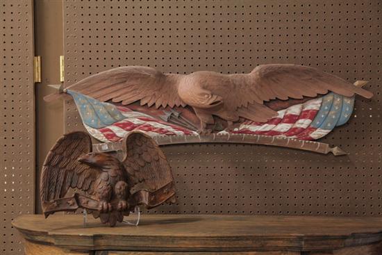 Appraisal: TWO CARVED EAGLES Wooden carved eagle with his head turned