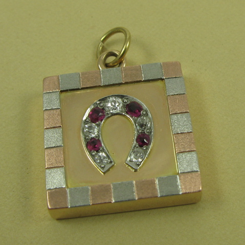 Appraisal: RUBY AND FOURTEEN KARAT GOLD PENDANT the square shaped pendant