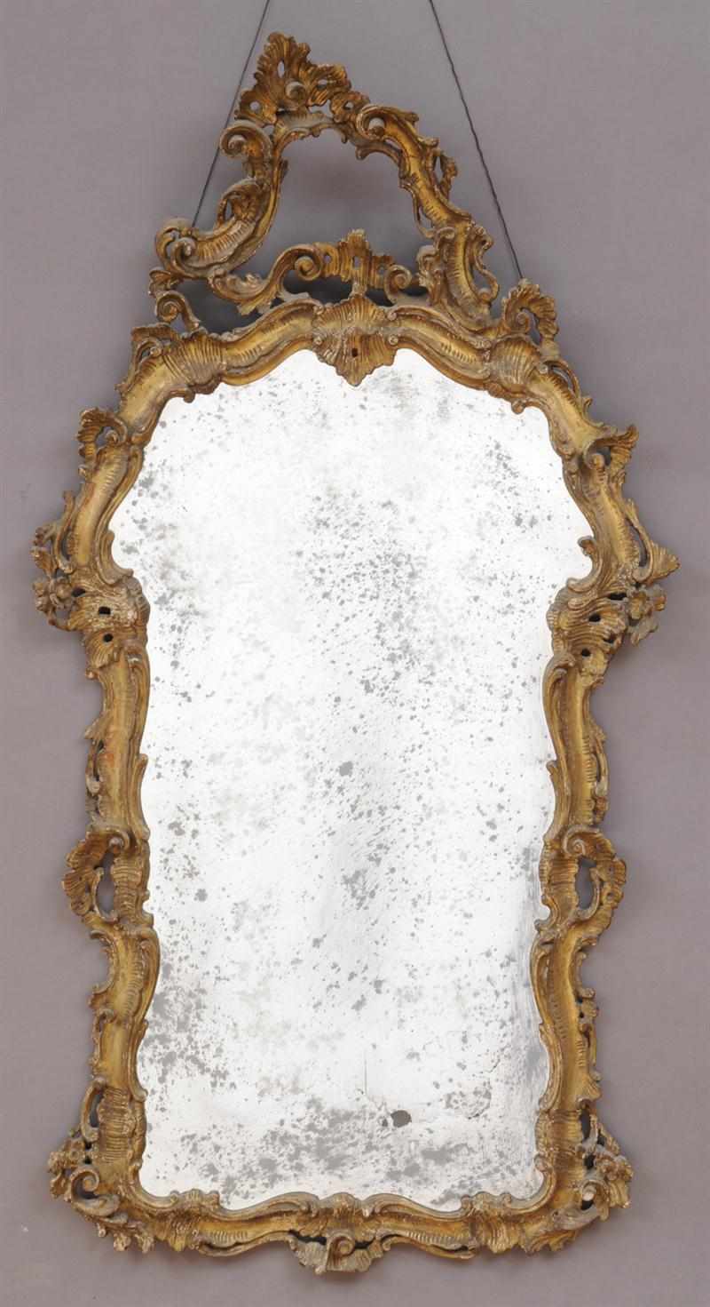 Appraisal: ITALIAN ROCOCO CARVED GILTWOOD MIRROR The shaped frame carved with