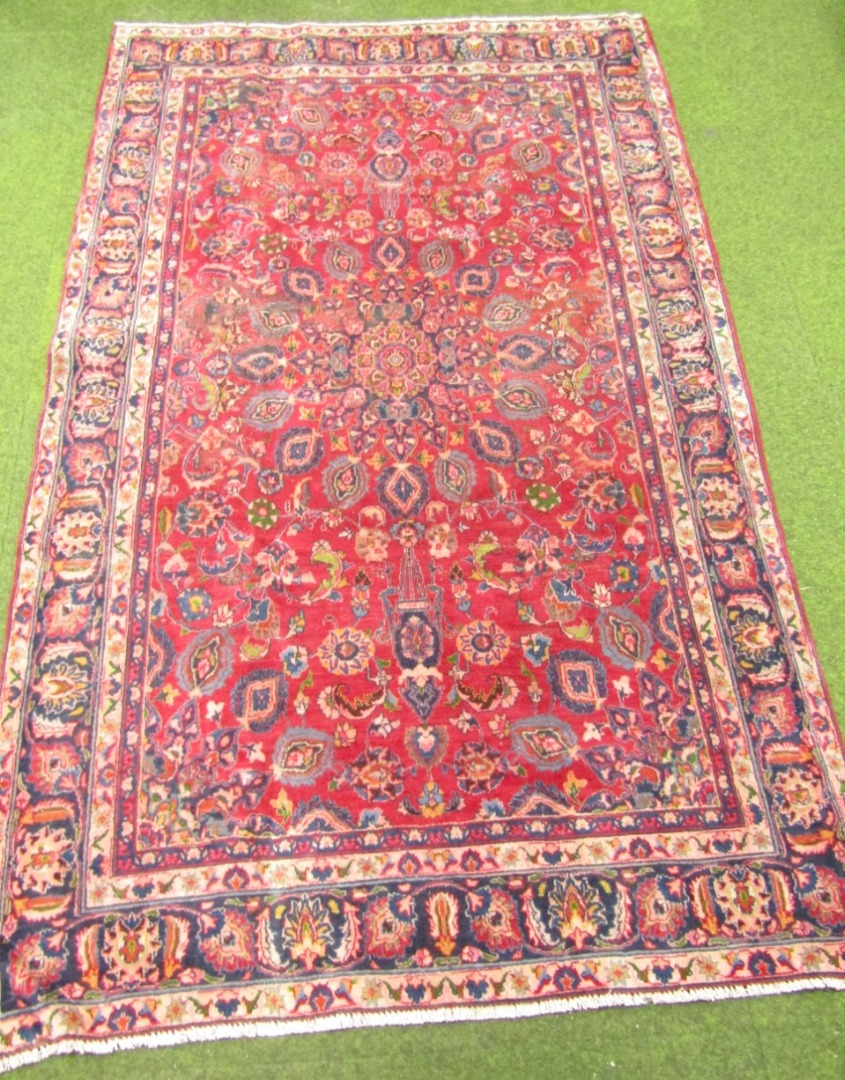 Appraisal: A Mashad rug medallion style in red and ink blue