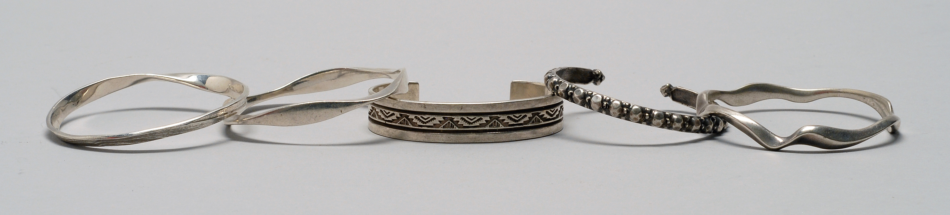 Appraisal: COLLECTION OF FIVE STERLING SILVER BRACELETS In varying designs Approx