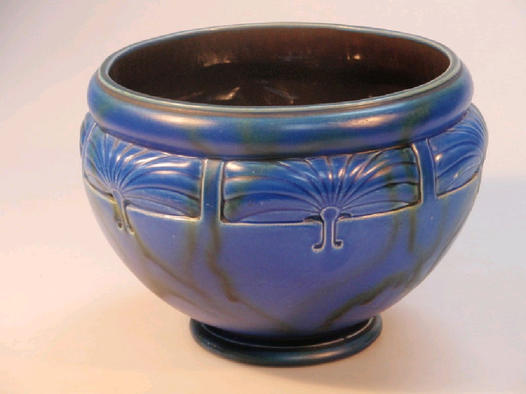 Appraisal: A Bretby pottery jardinier with stylised moulding blue ground with