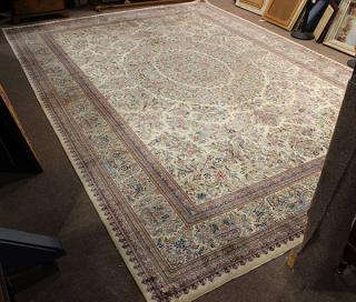 Appraisal: Pakastani Tabriz style carpet with floral decoration on a cream