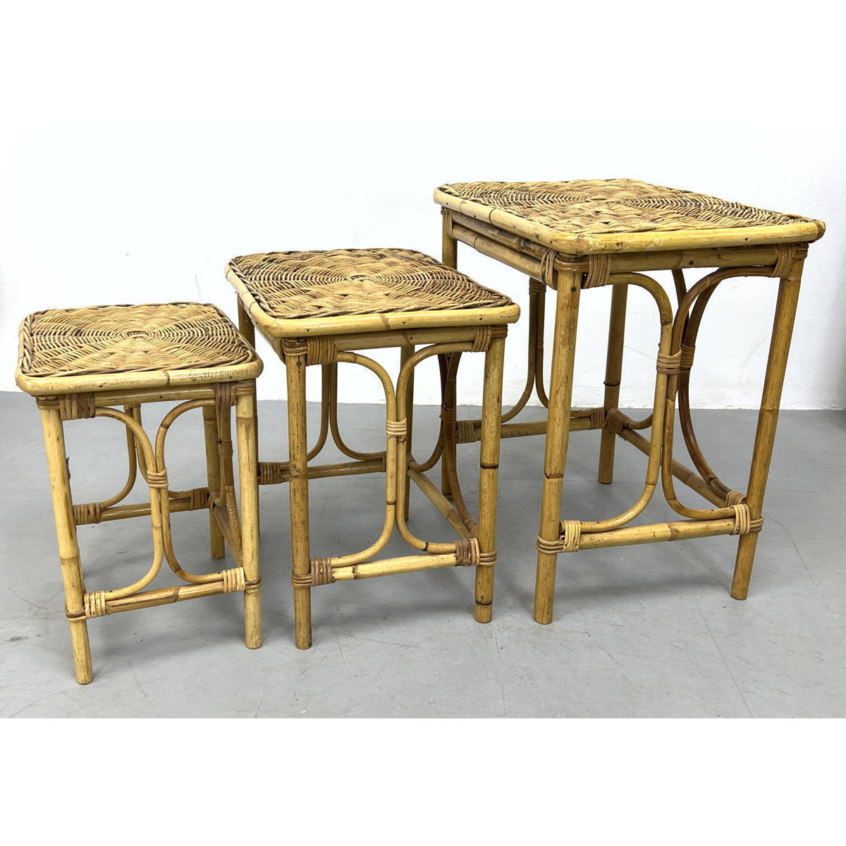 Appraisal: Set Woven Rattan Nesting Side End Tables Spiral design woven