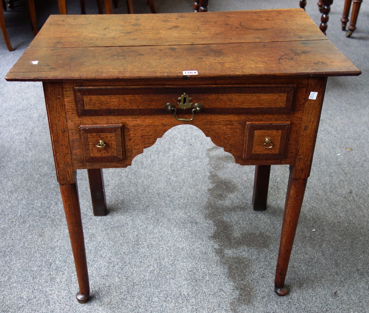 Appraisal: A George III mahogany crossbanded oak lowboy with three frieze