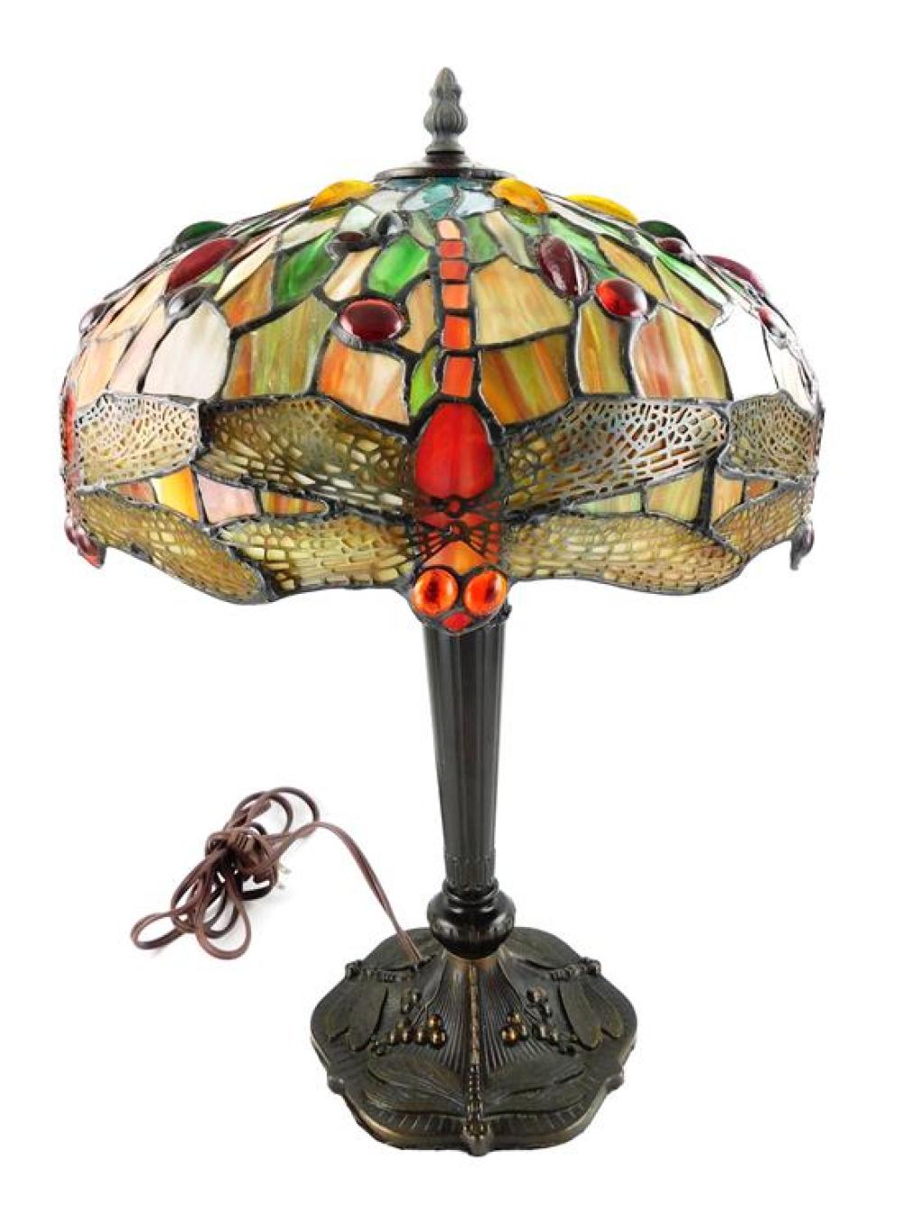 Appraisal: Reproduction stained glass dragonfly lampshade th C on metal table-type