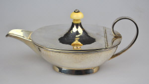 Appraisal: A Scottish planished silver sauce boat the hinged cover with