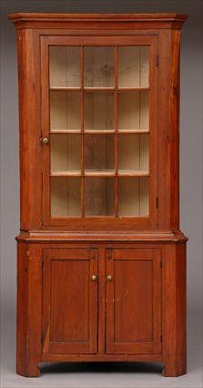 Appraisal: AMERICAN CHERRY TWO-PART CORNER CABINET The molded cornice above a