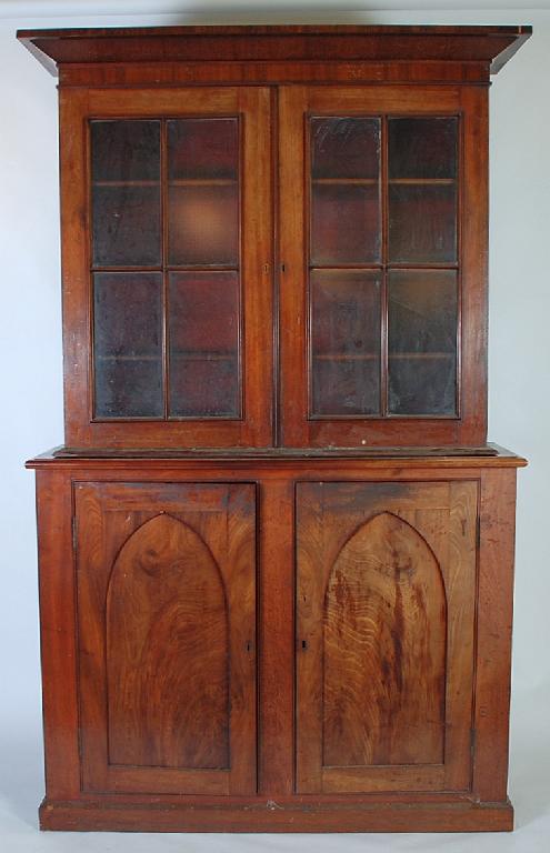 Appraisal: EARLY NINETEENTH CENTURY ASSOCIATED MAHOGANY BOOKCASE the flared cornice above