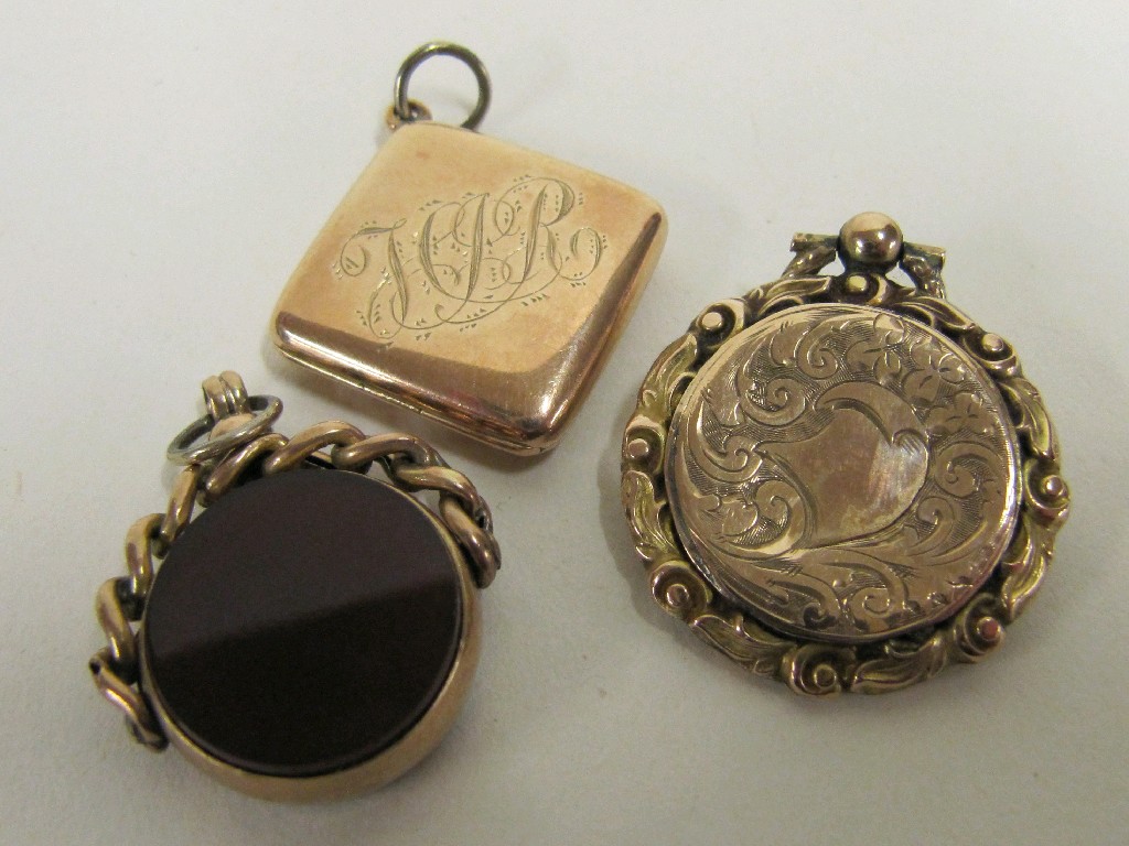 Appraisal: Lot comprising two Victorian gold photo lockets and a revolving