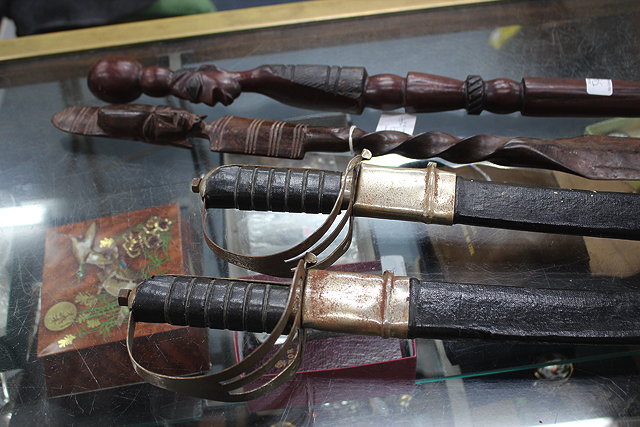 Appraisal: TWO OLD SWORDS in scabbards together with two carved hardwood