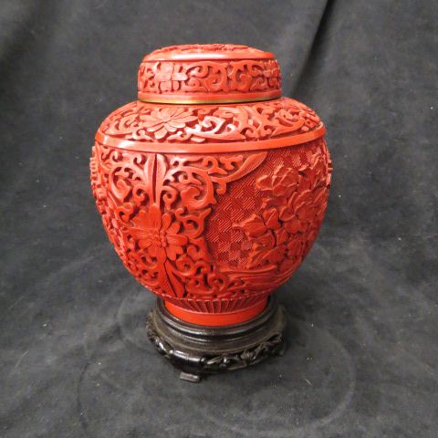 Appraisal: Chinese Cinnabar Jar deeply carved floral plus wooden stand excellent