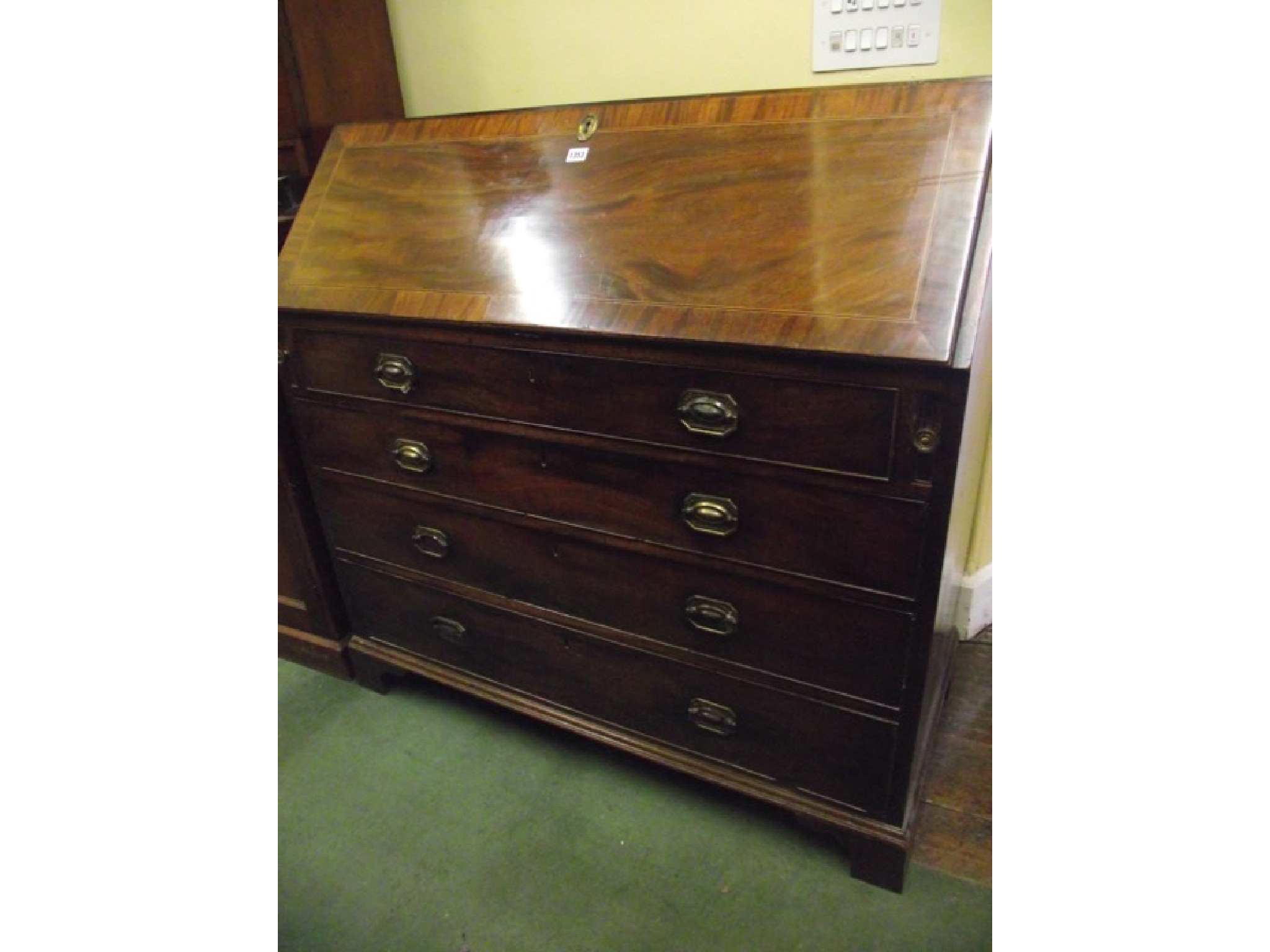 Appraisal: A Georgian mahogany writing bureau with four long graduated drawers