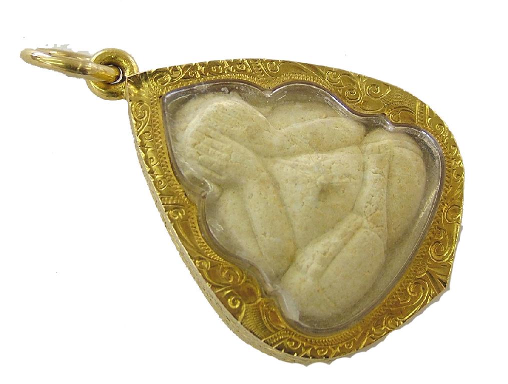 Appraisal: Unusual engraved yellow metal pendant enclosed with a Phra Pitta