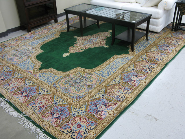 Appraisal: PERSIAN KERMAN CARPET central floral medallion on plain green field