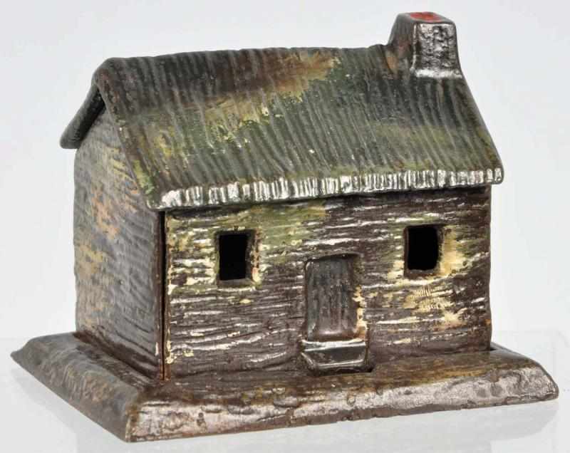 Appraisal: Cast Iron Cabin Still Bank Description Nice detail and casting