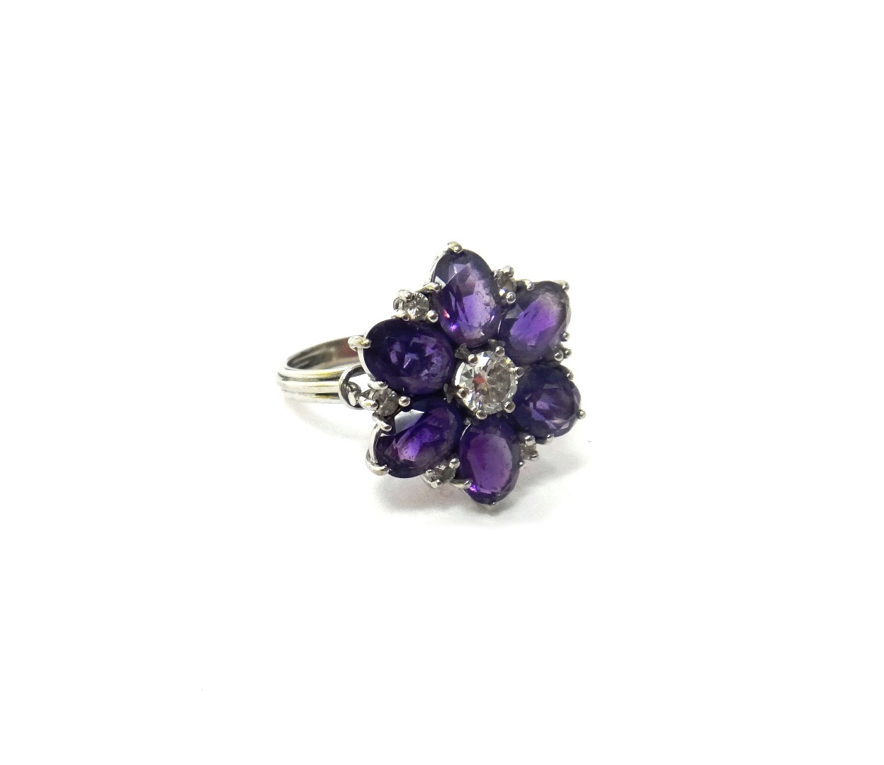 Appraisal: A diamond and amethyst set hexagonal cluster ring claw set