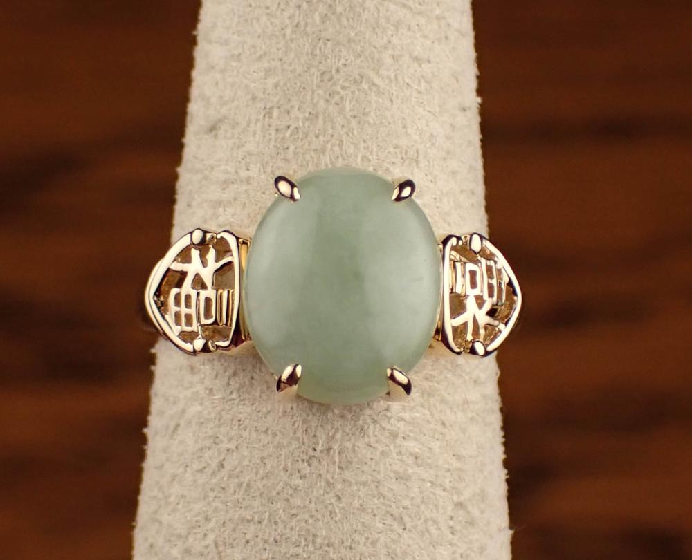 Appraisal: JADE AND FOURTEEN KARAT YELLOW GOLD RING with four gold