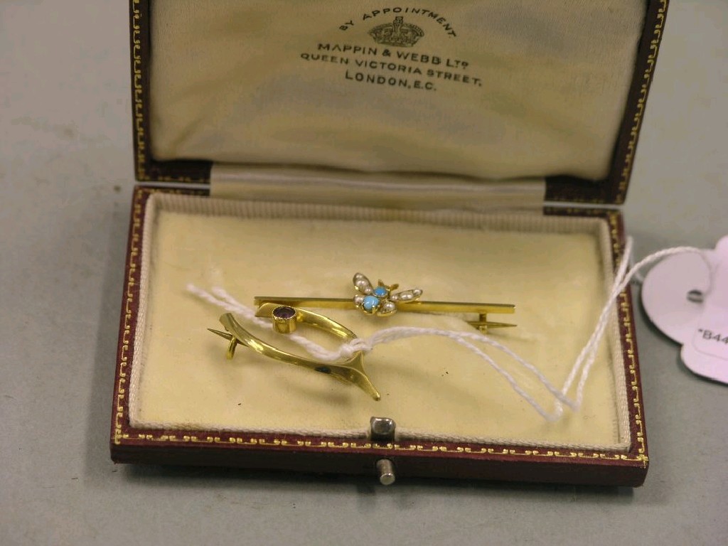 Appraisal: A ct gold wish-bone brooch set single amethyst and a