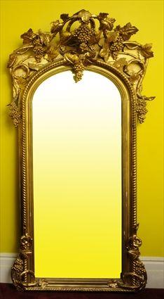 Appraisal: ROCOCO REVIVAL GILTWOOD OVERMANTEL MIRROR The arched mirror plate in