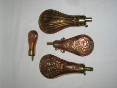 Appraisal: FOUR COPPER POWDER FLASKS with brass mounts and steel spring