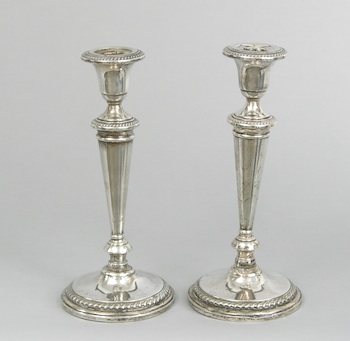 Appraisal: A Pair of Weighted Sterling Silver Candlesticks A pair of