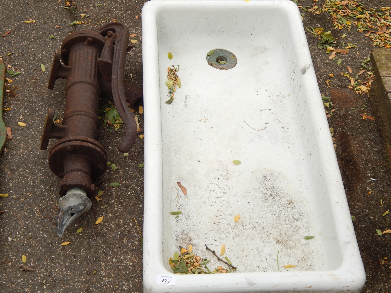 Appraisal: A small cast iron well pump and porcelain sink