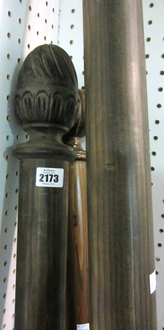 Appraisal: A group of three th century stained pine curtain poles