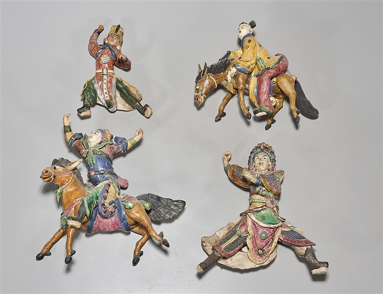 Appraisal: Four Japanese roof tile figures two on horseback x x