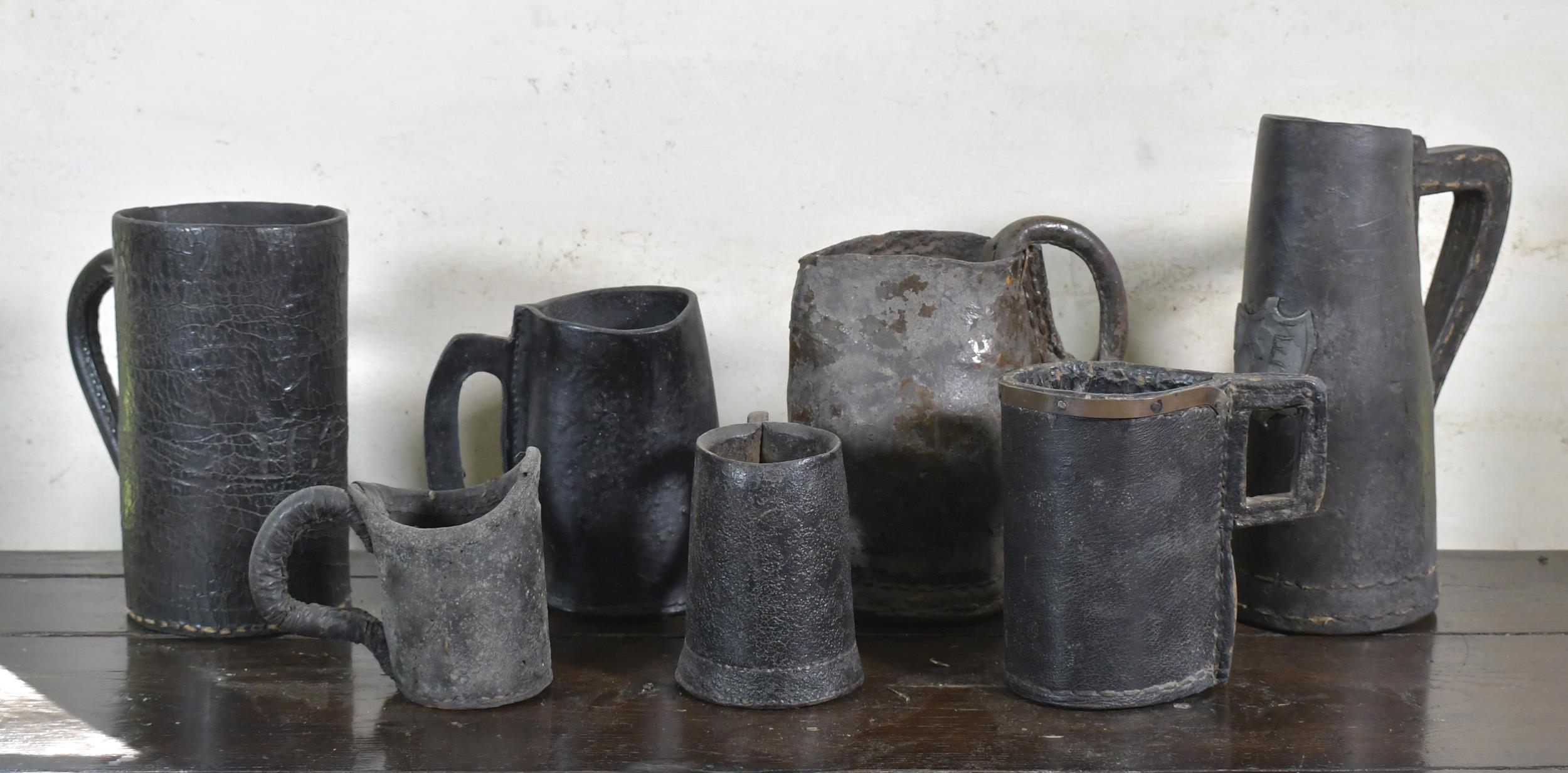 Appraisal: SEVEN EARLY LEATHER TANKARDS AND POURING JUGS th th C