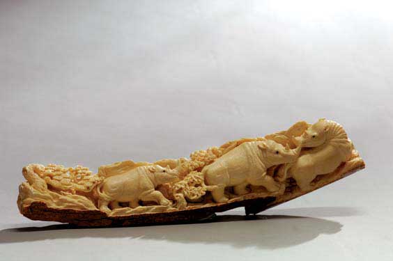 Appraisal: CARVED FOSSIL IVORY GROUP Well carved fossil mammoth ivory tusk