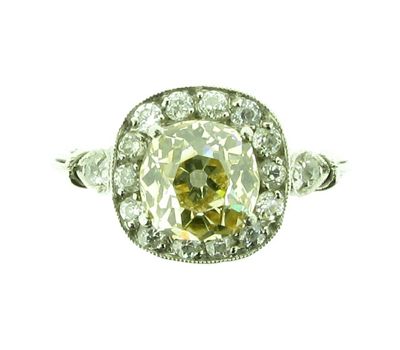 Appraisal: A diamond cluster ring The cushion shaped diamond is set