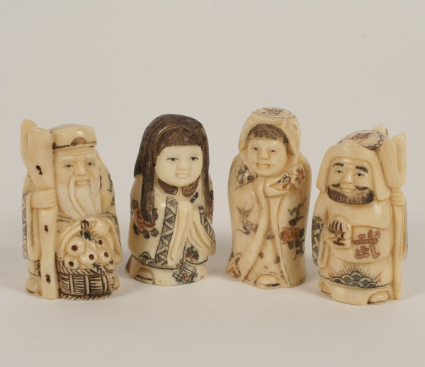 Appraisal: Japanese carved ivory netsuke two male and two female figures