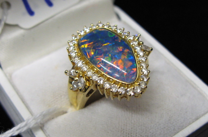 Appraisal: OPAL DIAMOND AND EIGHTEEN KARAT GOLD RING set with a