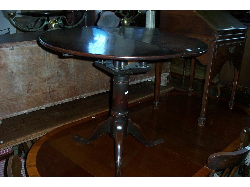 Appraisal: A Georgian mahogany snap top occasional table the circular top