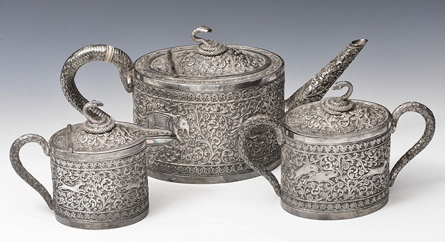 Appraisal: A MIDDLE EASTERN THREE PIECE TEA SET the teapot heavily