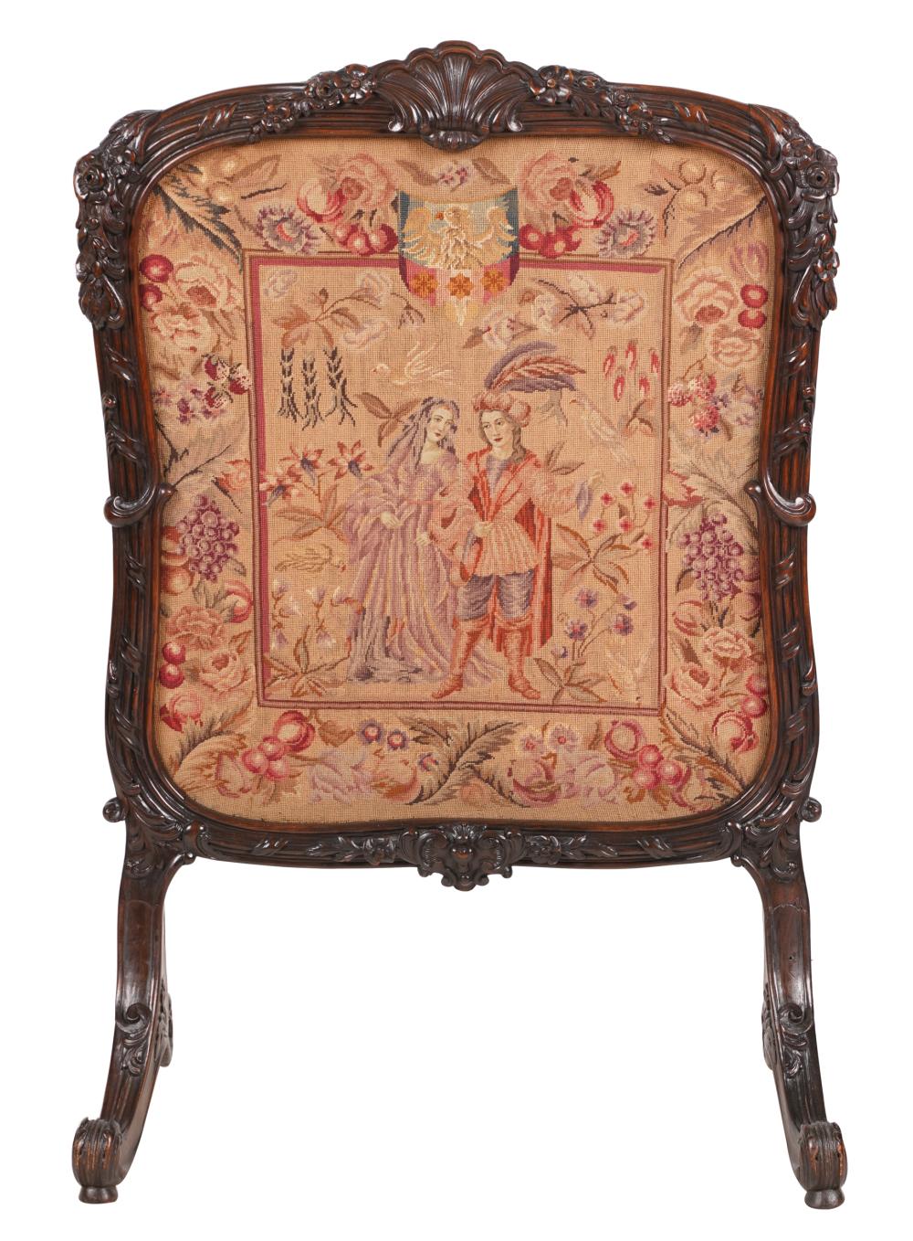 Appraisal: ITALIAN WALNUT FIRESCREENthe needlework depicting two figures with birds and