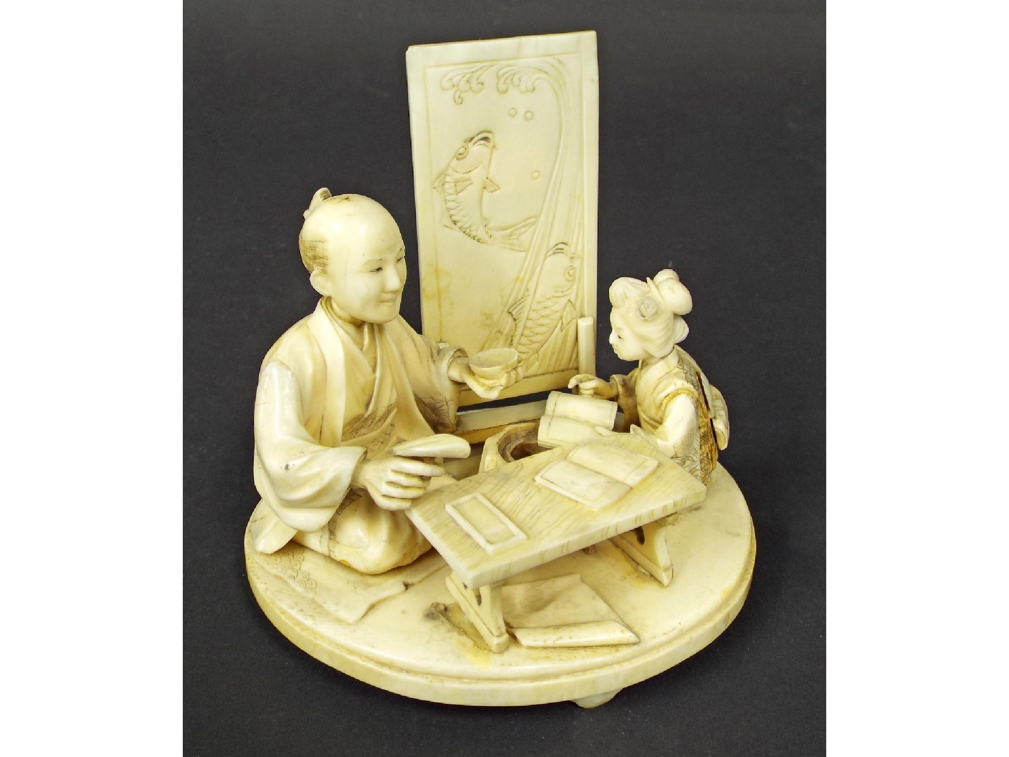 Appraisal: Japanese School carved ivory okimono of a scholar and pupil