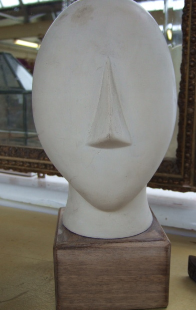 Appraisal: A biscuit porcelain bust of contemporary stylized form mounted on