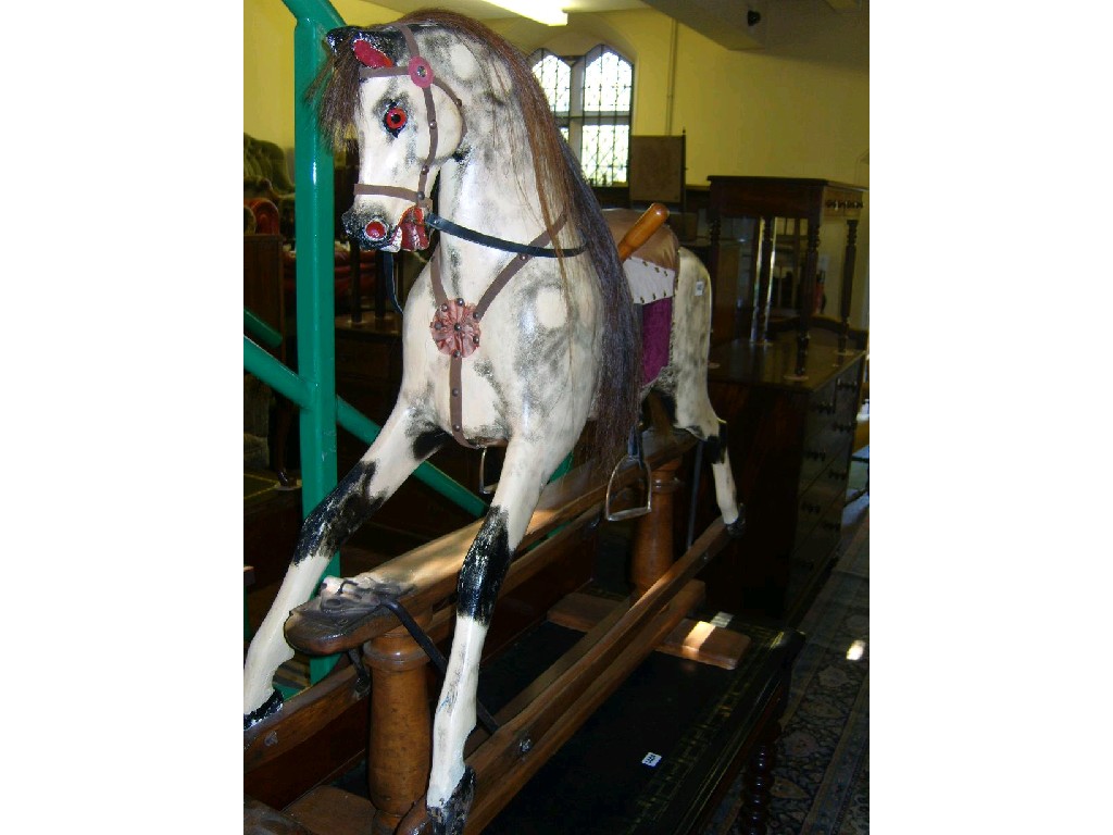 Appraisal: An Edwardian rocking horse with dappled painted finish raised on