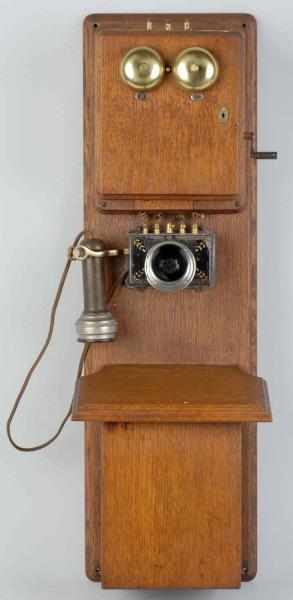 Appraisal: Stromberg-Carlson Two Box Telephone Description Circa Oak Early triplet with