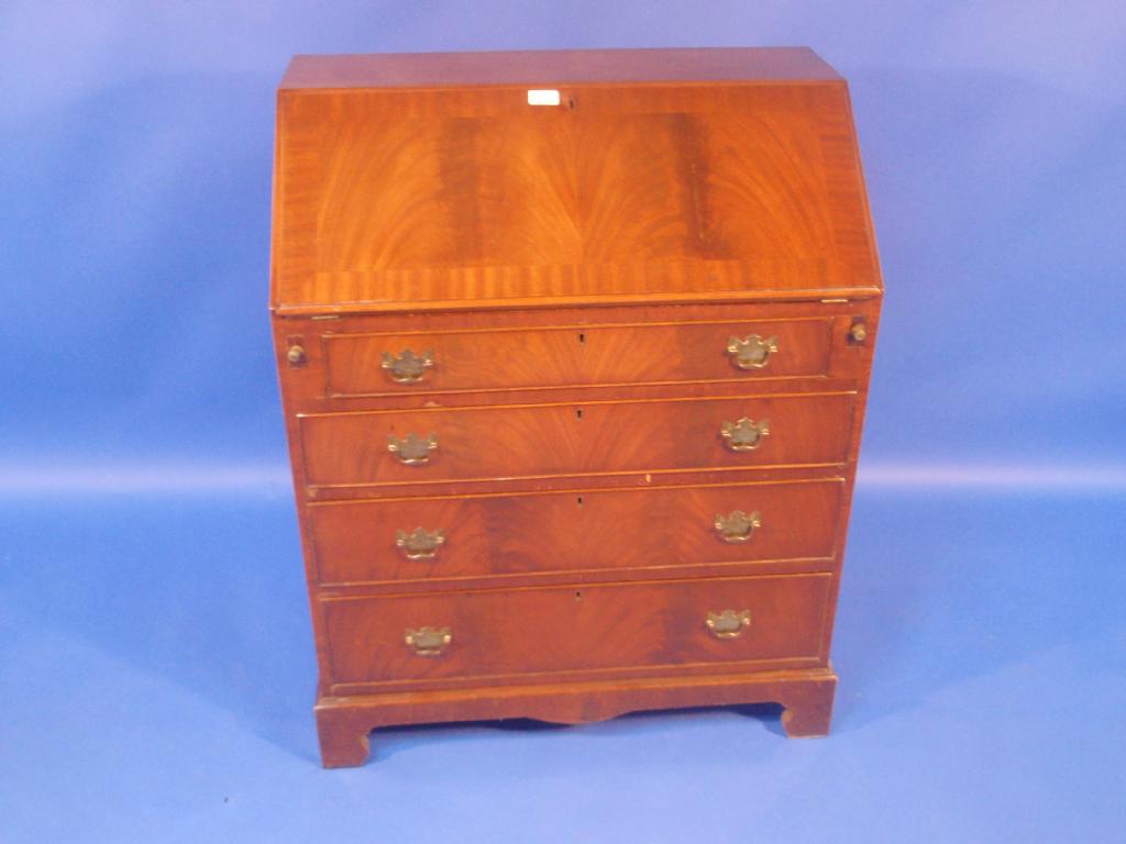 Appraisal: A reproduction flamed mahogany bureau wide