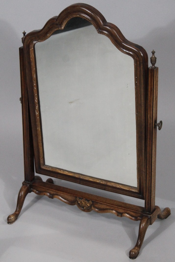 Appraisal: A late thC walnut framed table mirror the shaped glass